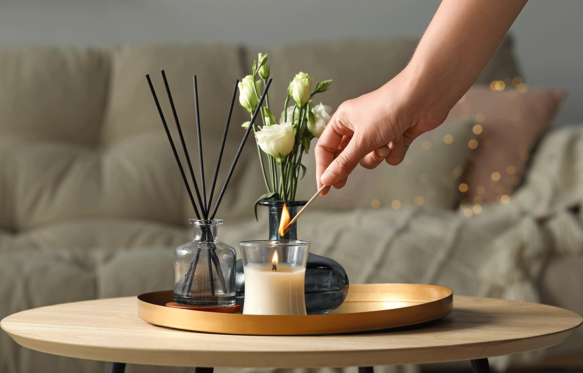 Reeds, oil, candle, flower in vase