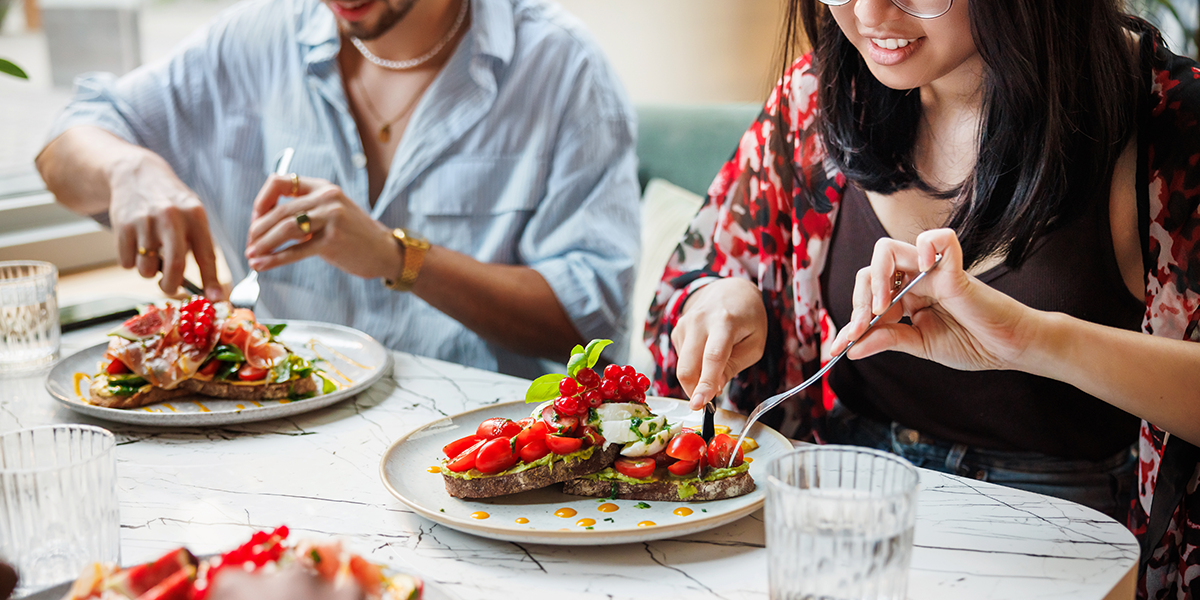 Two people eating a healthy meal.