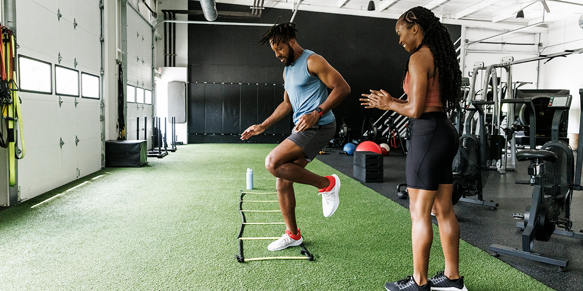 A man practices ladder drills for agility.