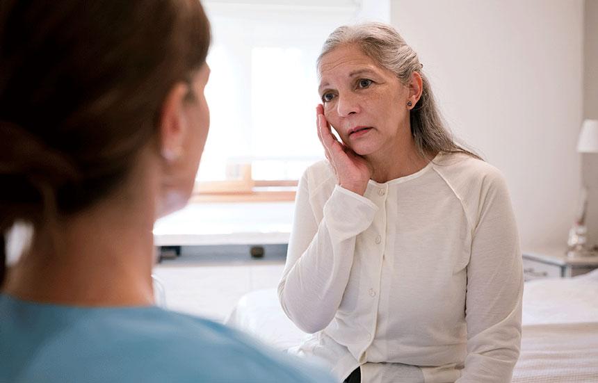 Older woman talking to doctor