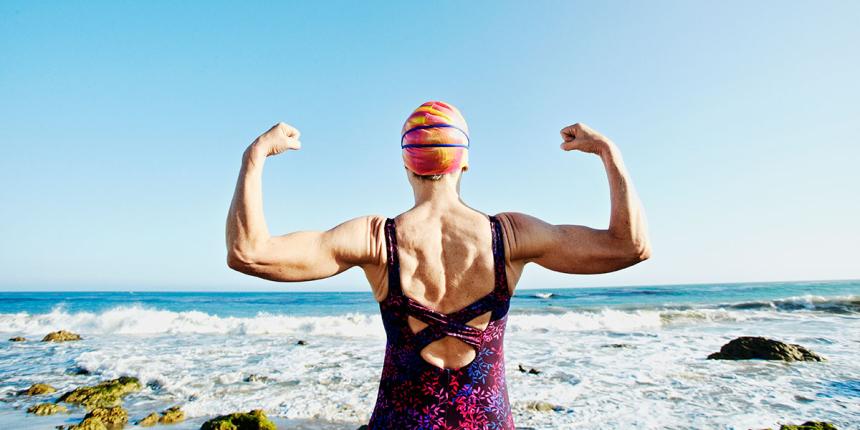 Older woman exercising at beach