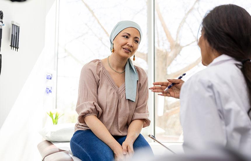 Female cancer patient talking to female physician