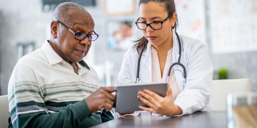 woman doctor helping older male patient