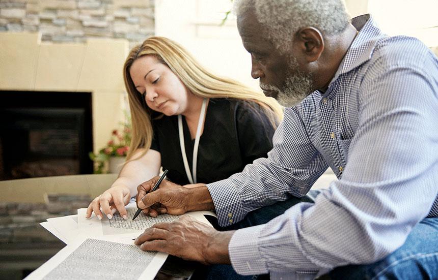 Two people filling out paperwork