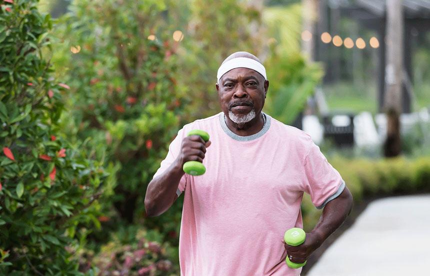 Man walking with weights in his hands