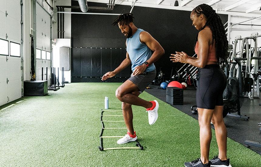 A man practices ladder drills for agility.