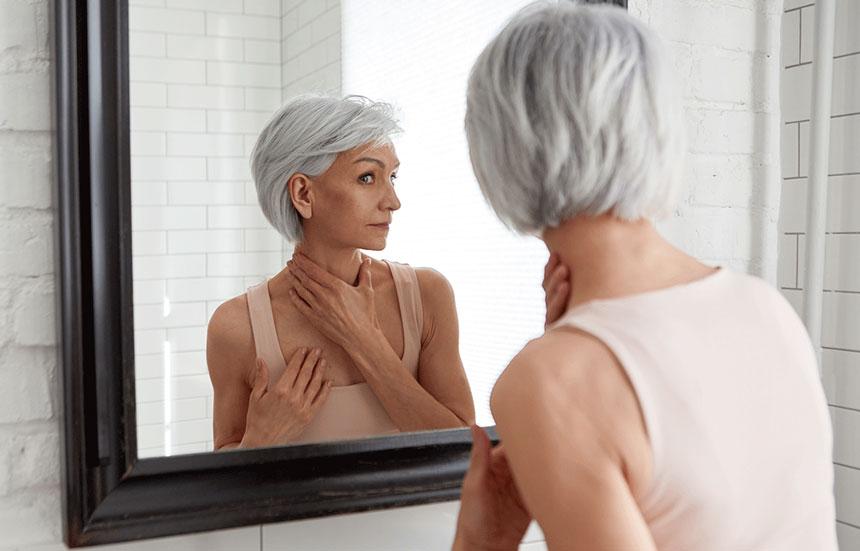 A women looking at herself in the mirror