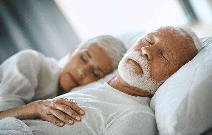 A couple sleeping in bed