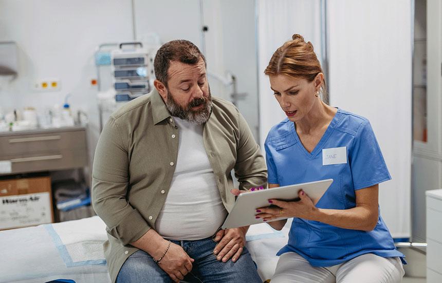 Overweight man talking to physician