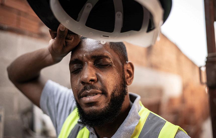 exhausted, overheated construction worker