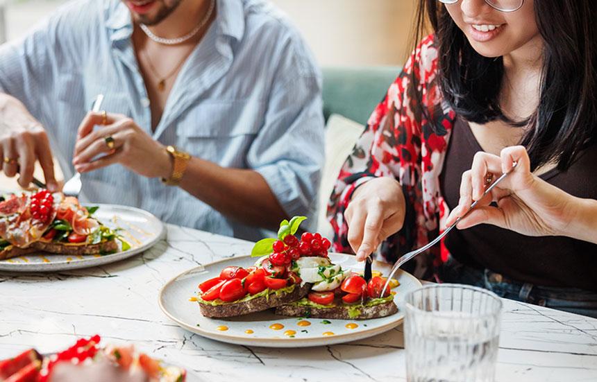 Two people eating a healthy meal.