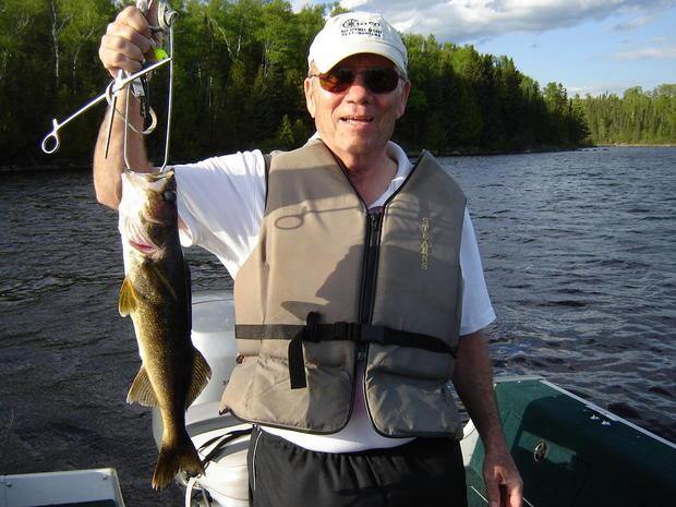 John Back Holding Up His Fishing Catch