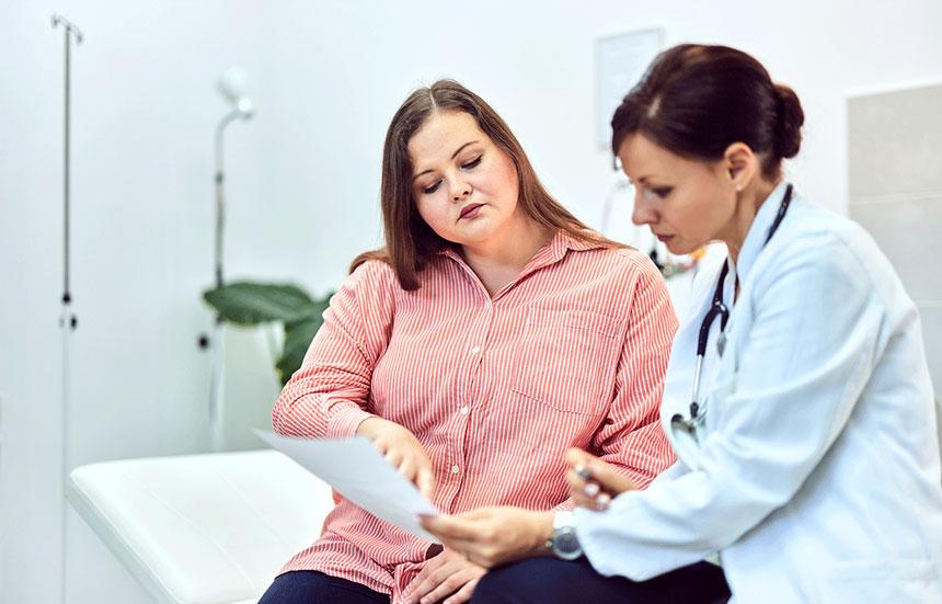 Overweight woman talking to doctor about lab results