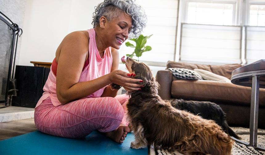 Woman playing on the floor with her dog