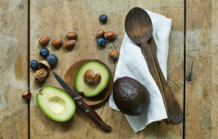 opened avocado and blueberries on tabletop