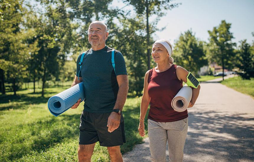 Middle age couple going to outdoor yoga