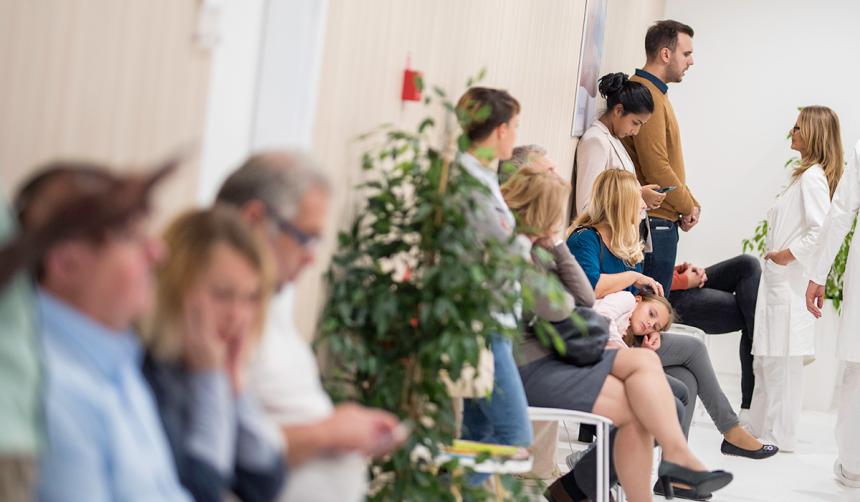 patients waiting in a crowded waiting room