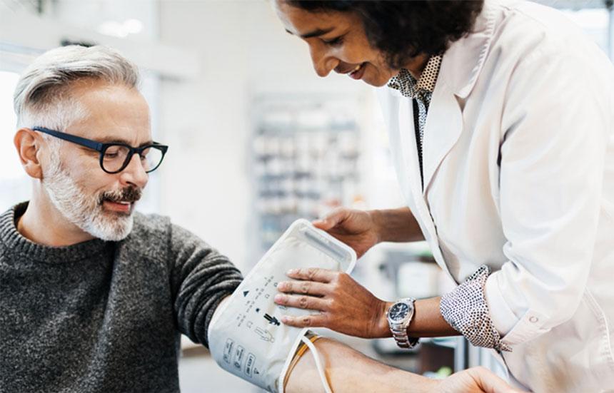 A doctor takes a patient's blood pressure