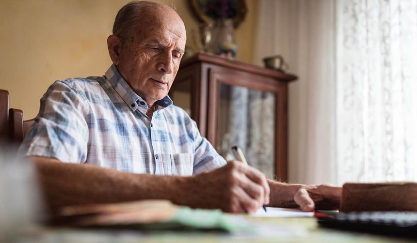 Older man filling out papers