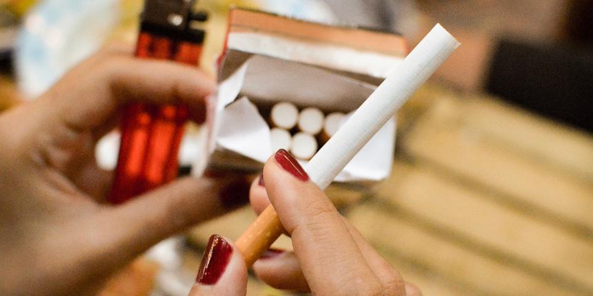 A woman about to light a cigarette. Quitting smoking can reduce your risk for host of diseases.