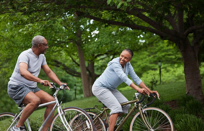 A couple cycling in a park