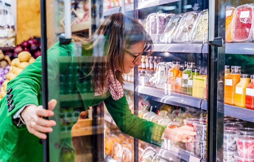 woman looking at fruit options in the grocery store