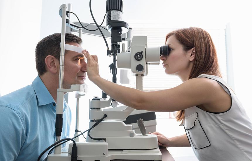 doctor performing eye exam on patient