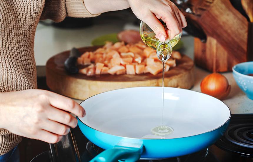 Oil poured into a blue stovetop pan