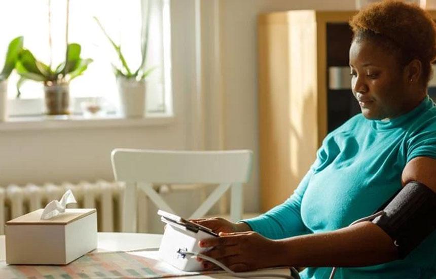 A woman checking her blood pressure.