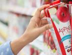 Woman pulling apple juice off the grocery shelf