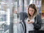 Woman shopping for almond milk at supermarket