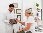 Male physician with female patient explaining spinal scan