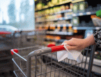 Woman wiping handle of shopping cart