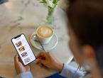 Coffee house patron looking at nutrition facts mobile app