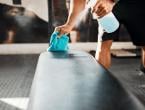 Wiping down bench in fitness center