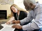 Two people filling out paperwork