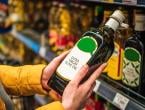 Woman looking at bottle of extra virgin olive oil at supermarket