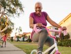 Grandmother riding tricycle with granddaughter.