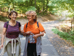 Two women walking in the shade during summer