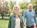 Older couple walking together in park